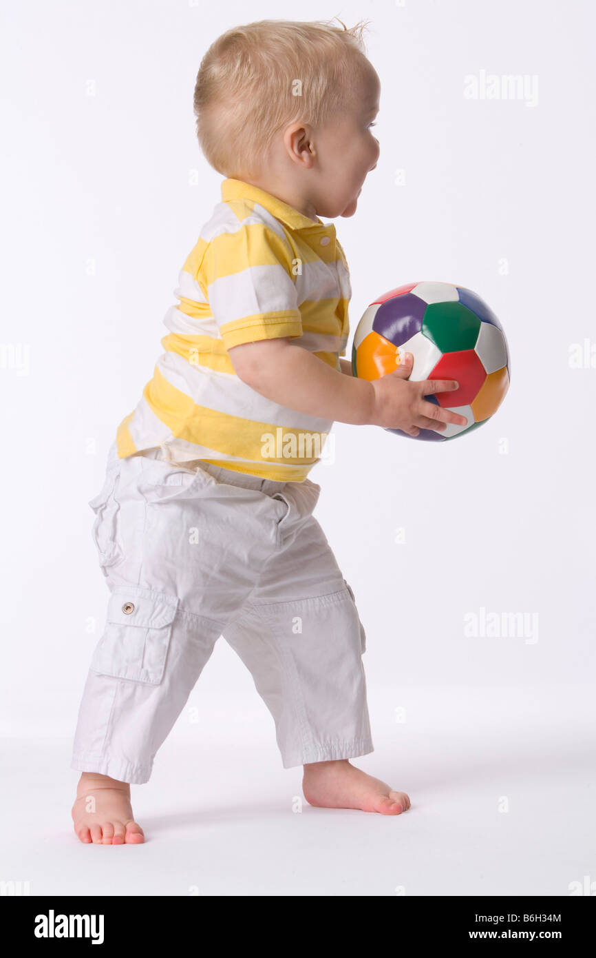 Toddler playing with a ball Stock Photo