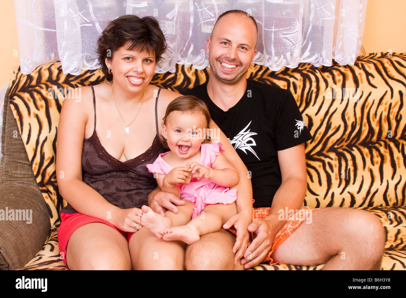 Smiling happy family man 32 years old with his daughter 16 months old and his woman 29 years old Stock Photo