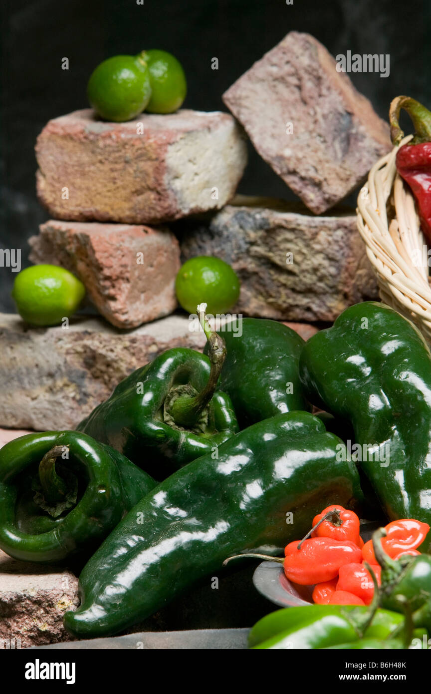 Variety of chile peppers and limes. Stock Photo