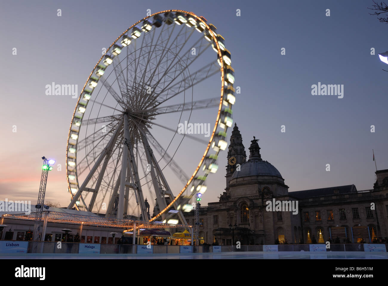 Cardiff Winter Wonderland's 'Admiral Eye' and ice rink in front of City Hall Stock Photo