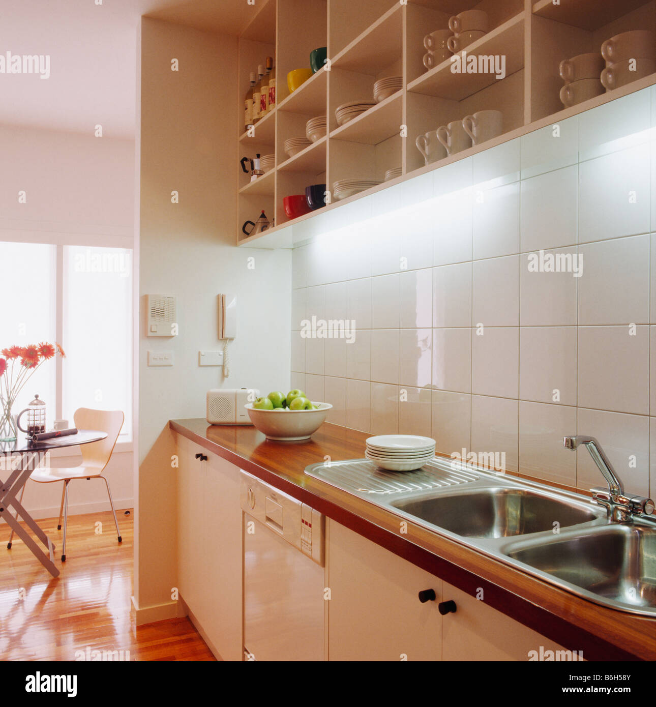 https://c8.alamy.com/comp/B6H58Y/cube-shelving-and-downlighting-above-white-tiled-wall-and-double-stainless-B6H58Y.jpg