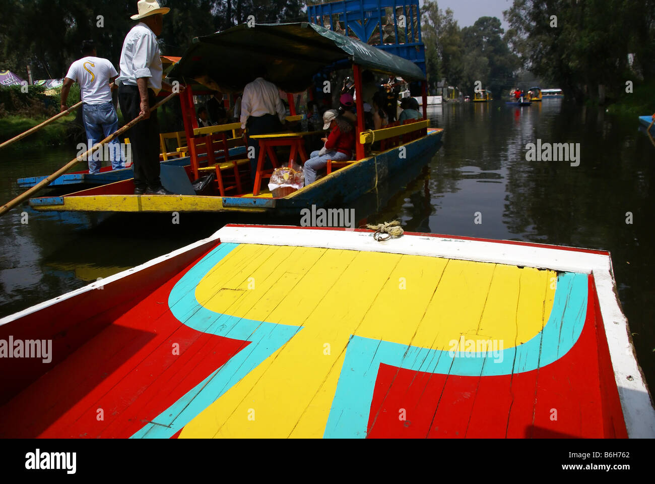 Bow of brightly colored boat Xochimilco canals floating gardens Mexico