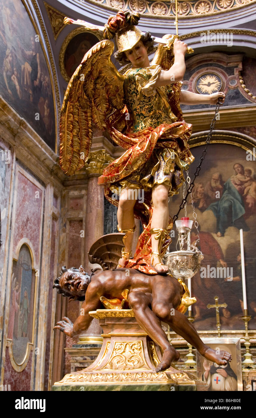 Statue of the archangel banishing Lucifer in church in Malta Stock