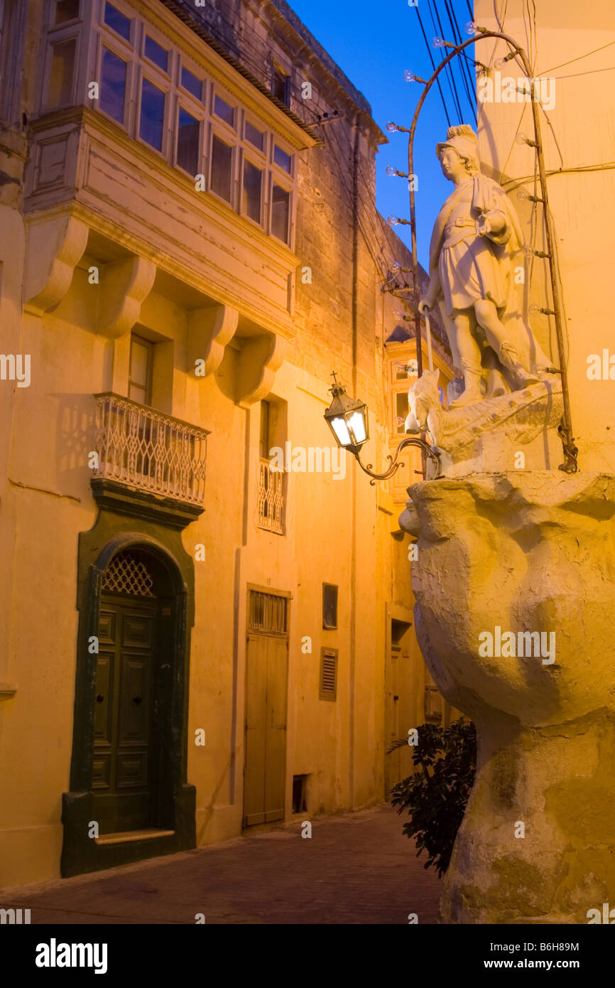 Statue of St George and old buildings at the old quarter of Rabat in Gozo, Malta Stock Photo