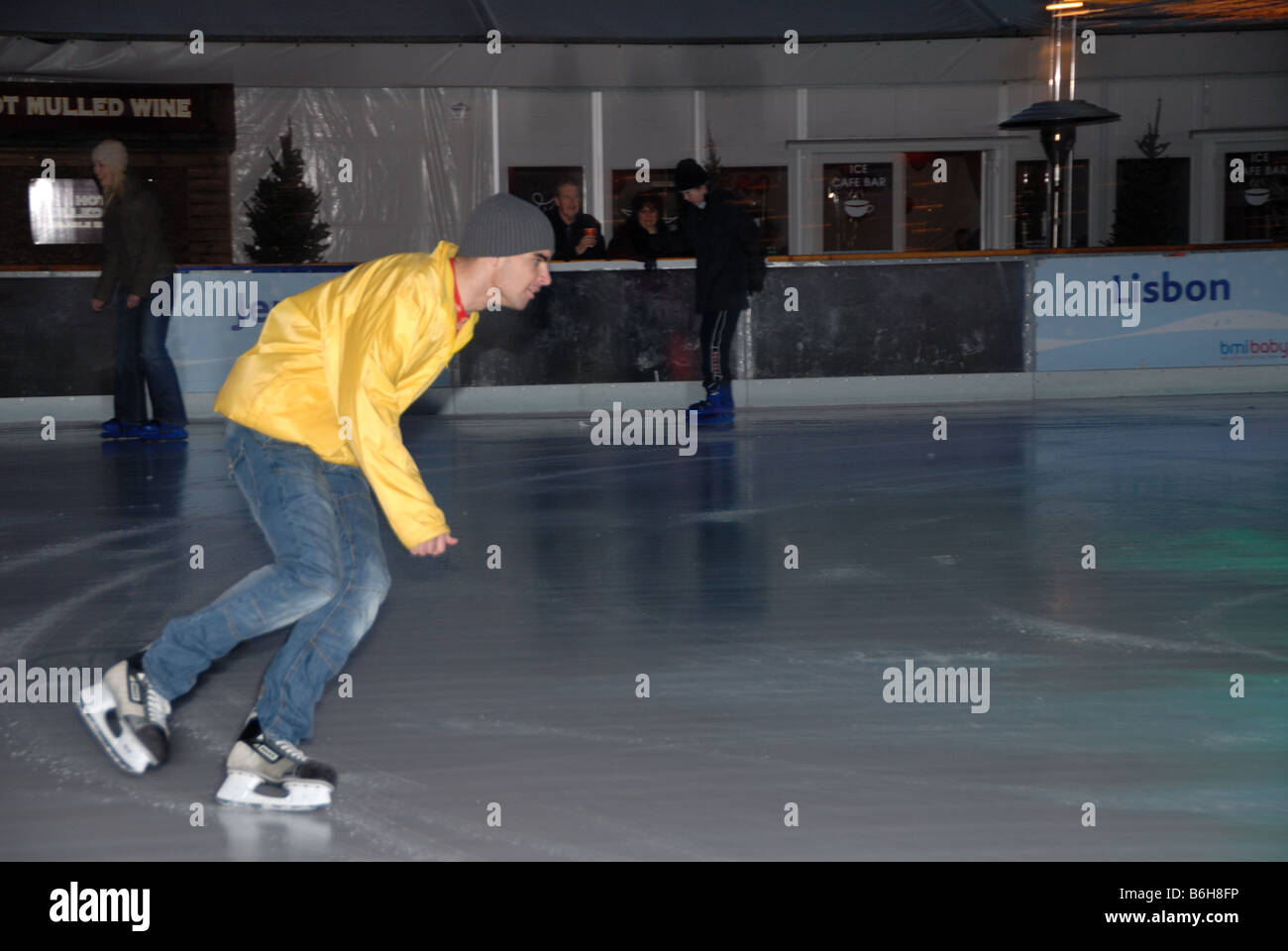 Safety Steward skating on the Cardiff Winter Wonderland ice rink Stock