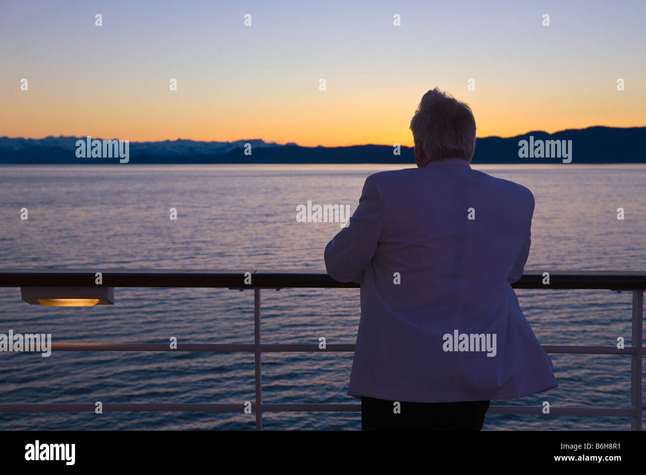 Man looking over rails of Cruise Ship Inside Passage Alaska USA Stock Photo