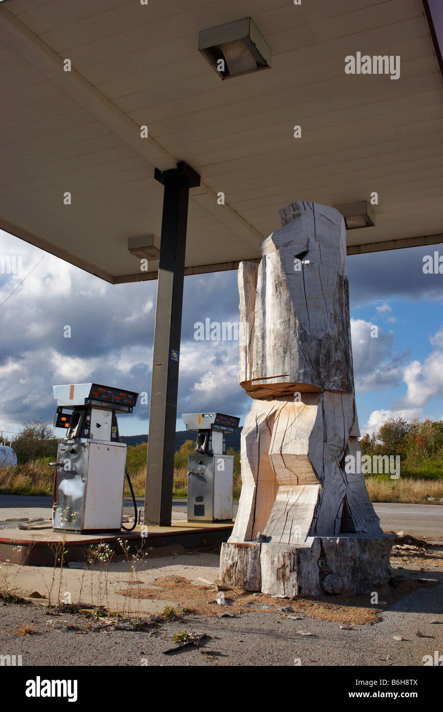 A large mysterious carving in progress on the grounds of an abandoned gas station Davis West Virginia Stock Photo