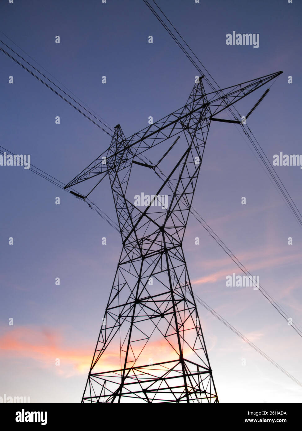 High voltage power lines and Transmission Tower at dusk Stock Photo