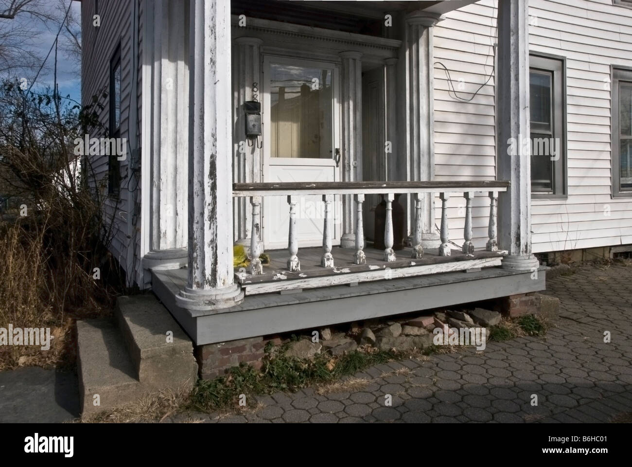 dilapidated entry porch with concrete stoop, Montgomery, New York, USA Stock Photo