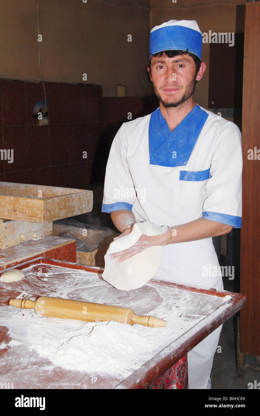 A baker making traditional unleavened bread in a tandoori oven in Turkey Stock Photo