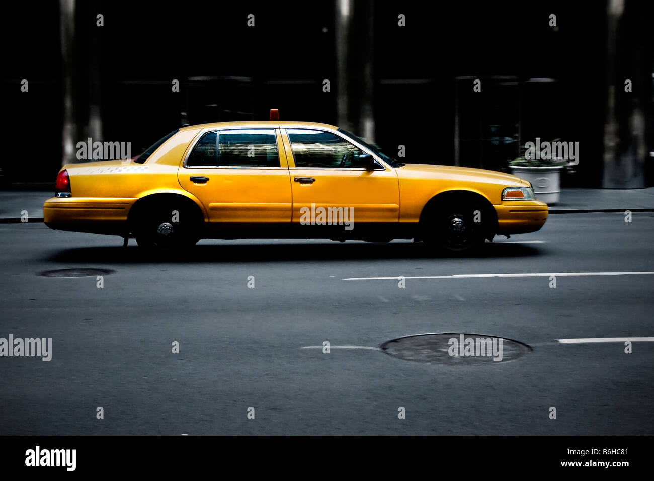Dirty New York City yellow cab on road in evening Stock Photo