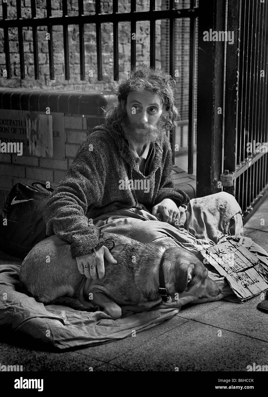 A homeless person and dog begging on the streets of London Stock Photo