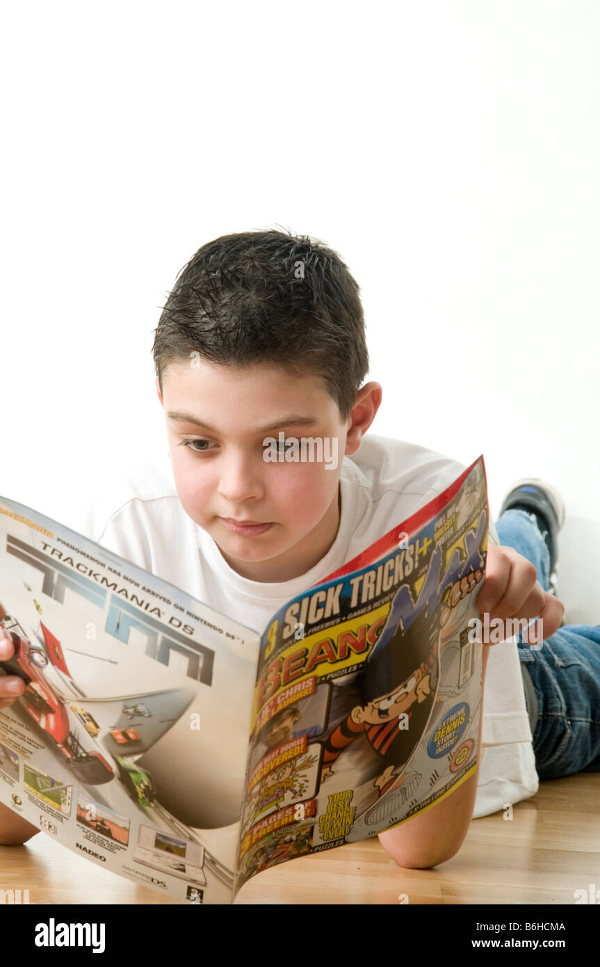 boy child reading comic beano dandy boys read literacy funny fun comics publishing publisher skills educational education Stock Photo