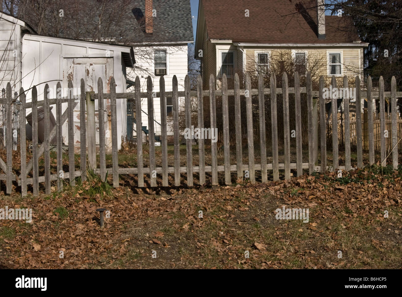 weathered wooden picket fence & back yards, Montgomery, New York, USA Stock Photo