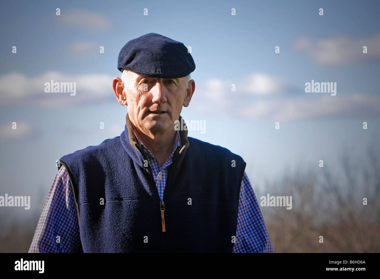 Senior man in flat cap looking thoughtful outside Stock Photo Alamy