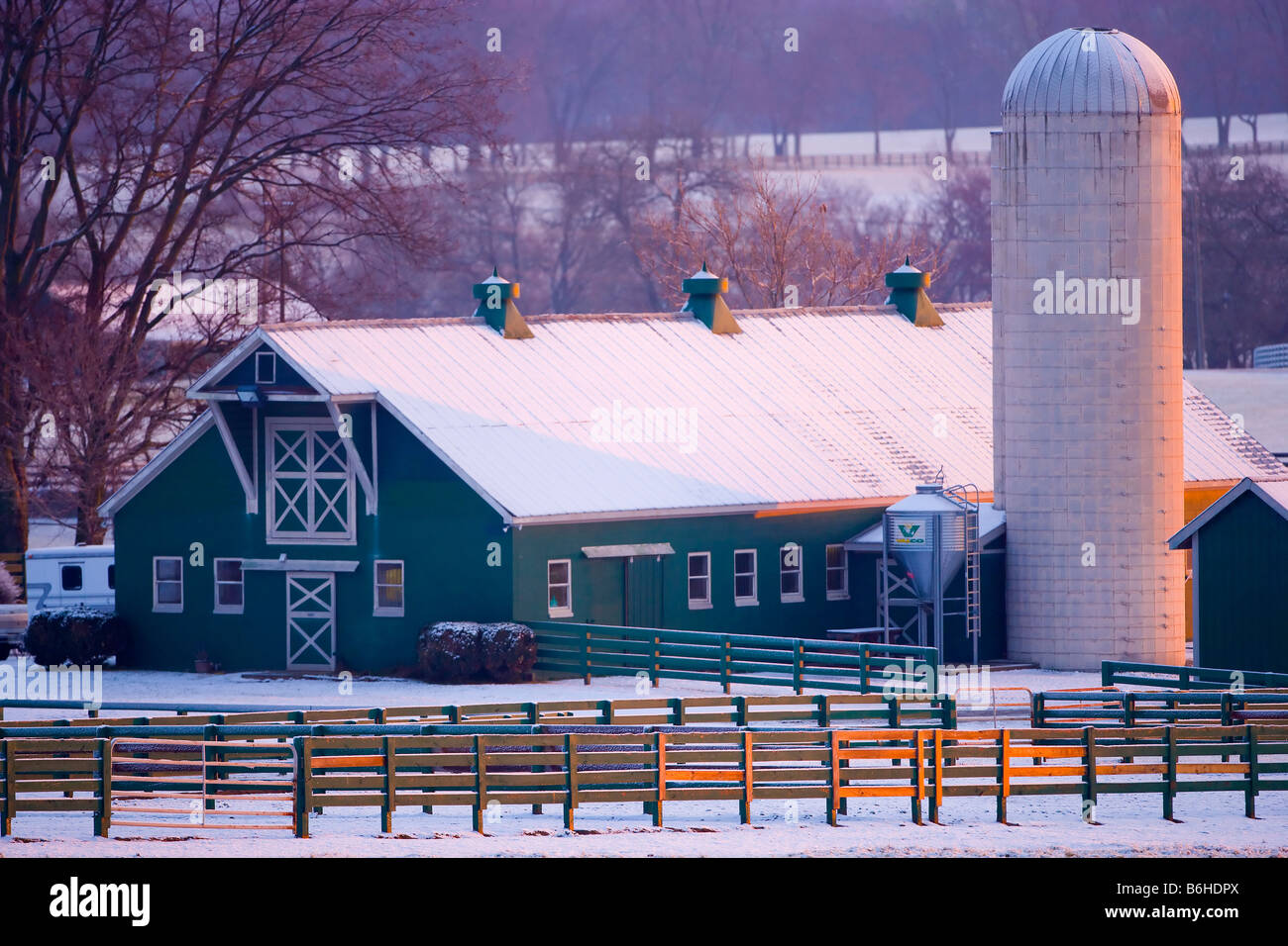 Sunrise on a barn and grain silo with a fresh snow, Brentwood, Tennessee Stock Photo