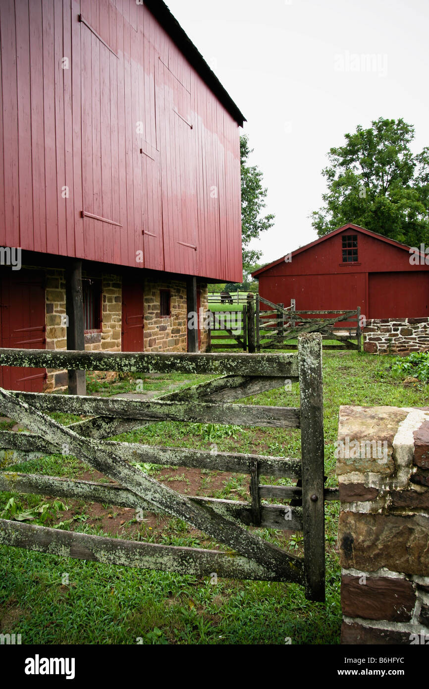 A stockade area of an old Colonial American farmstead with a stone/wood ...