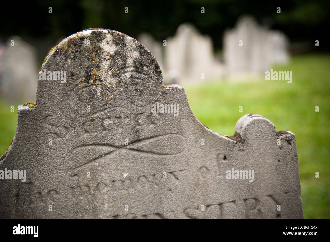 Detail of an early/colonial American marble tombstone/grave marker with the word 'sacred' carved at the top of the stone. Stock Photo