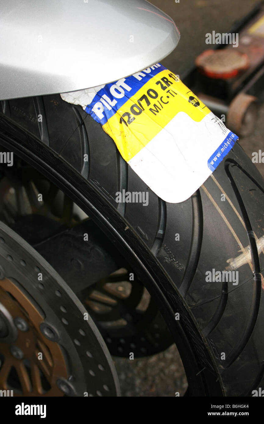 New front tyre fitted to motorcycle, with the label still attached