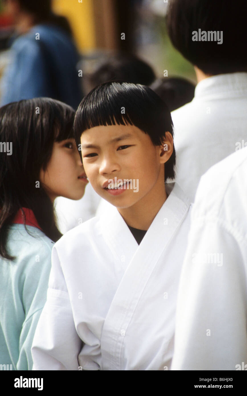 Asian-American boy in karate uniform awaits chance to compete. Stock Photo