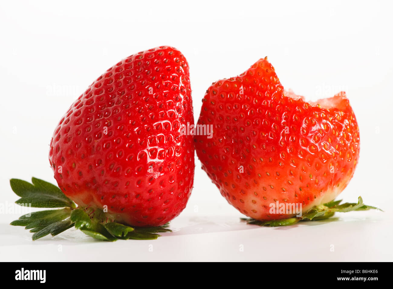 two strawberries on white background Stock Photo - Alamy