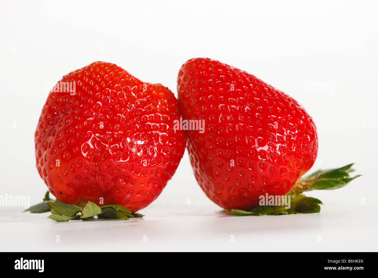 two strawberries on white background Stock Photo - Alamy