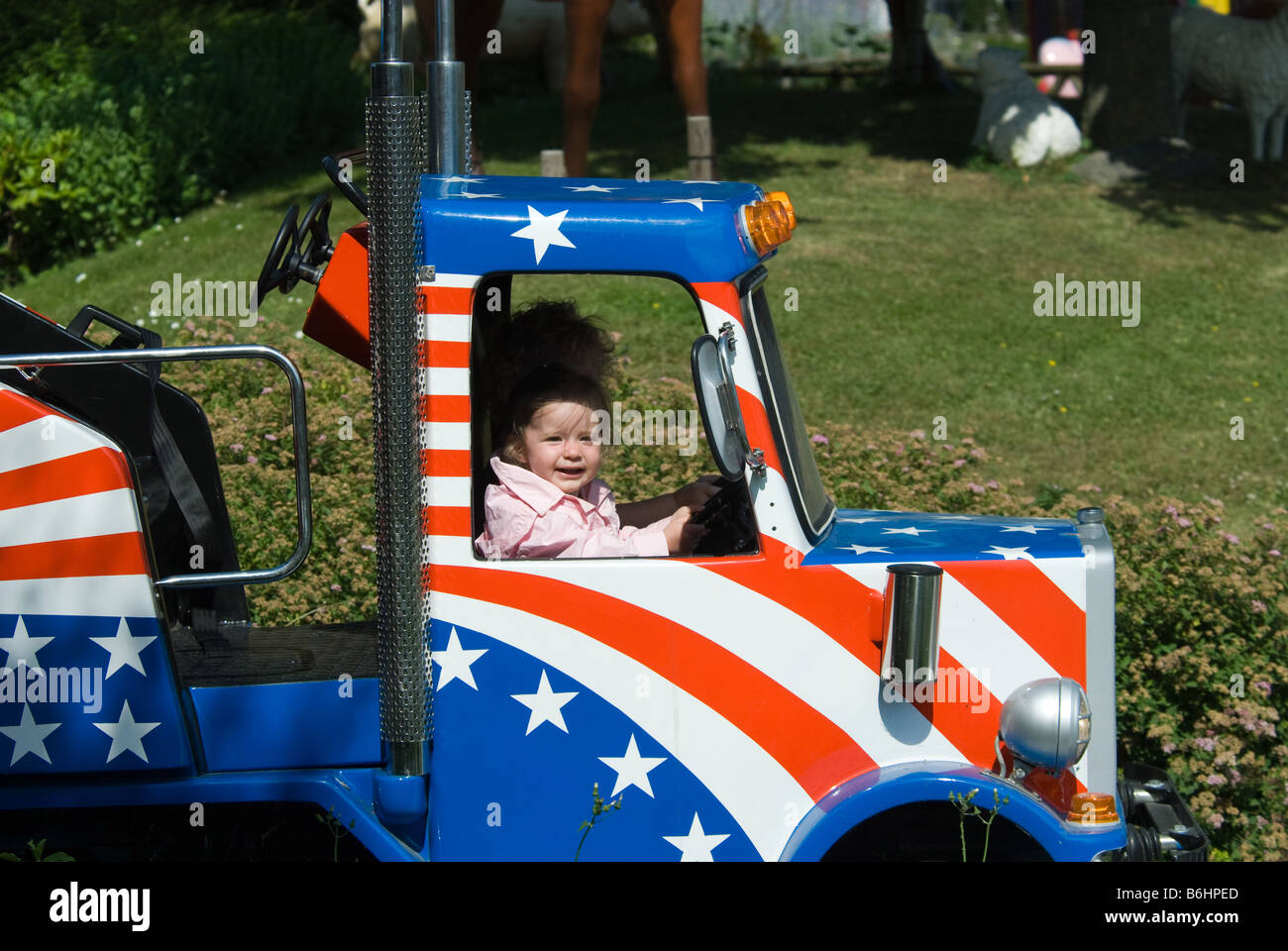 cute girl in a truck at an amusement park Stock Photo