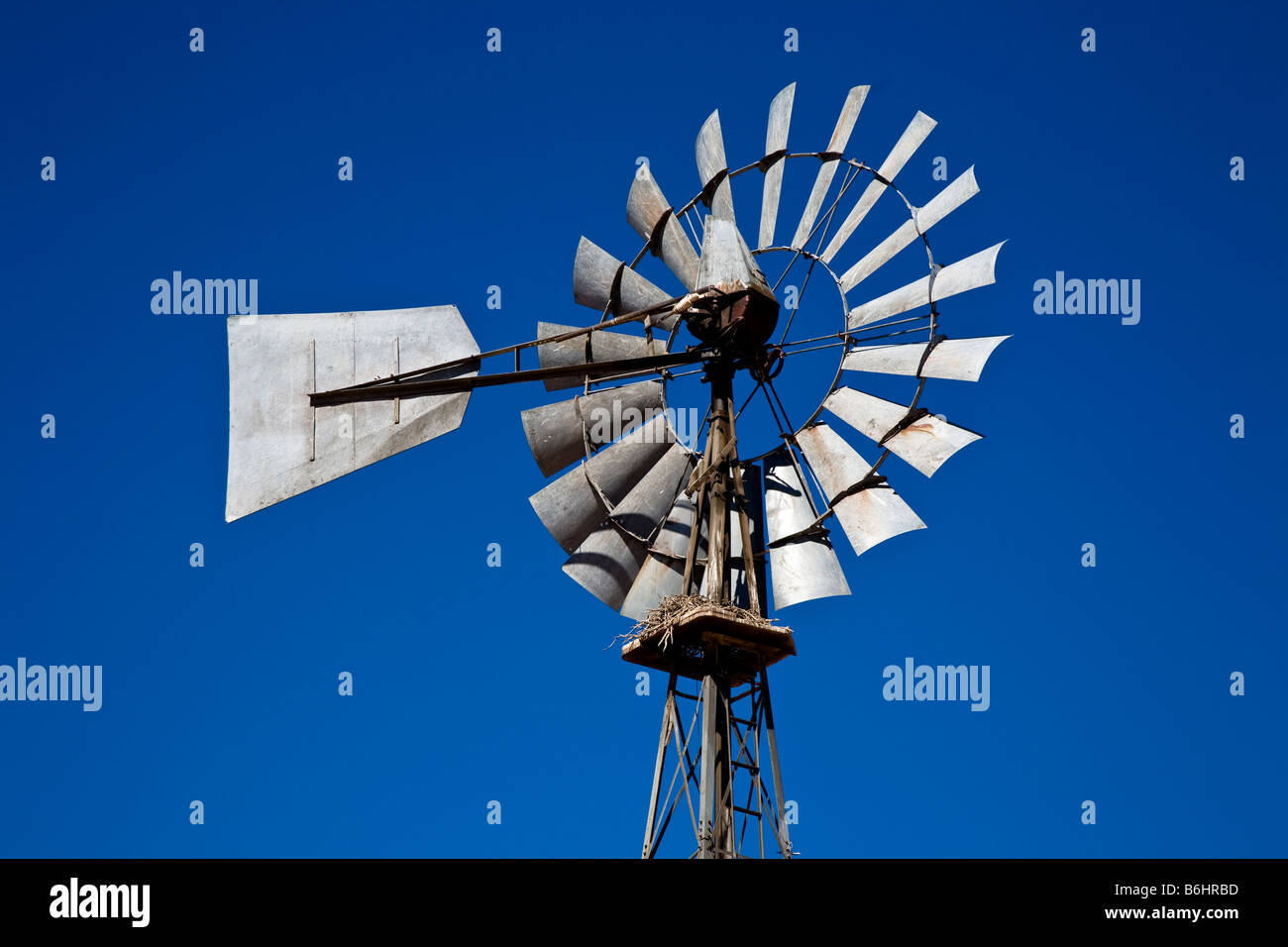 Wind pump against a clear blue sky Stock Photo