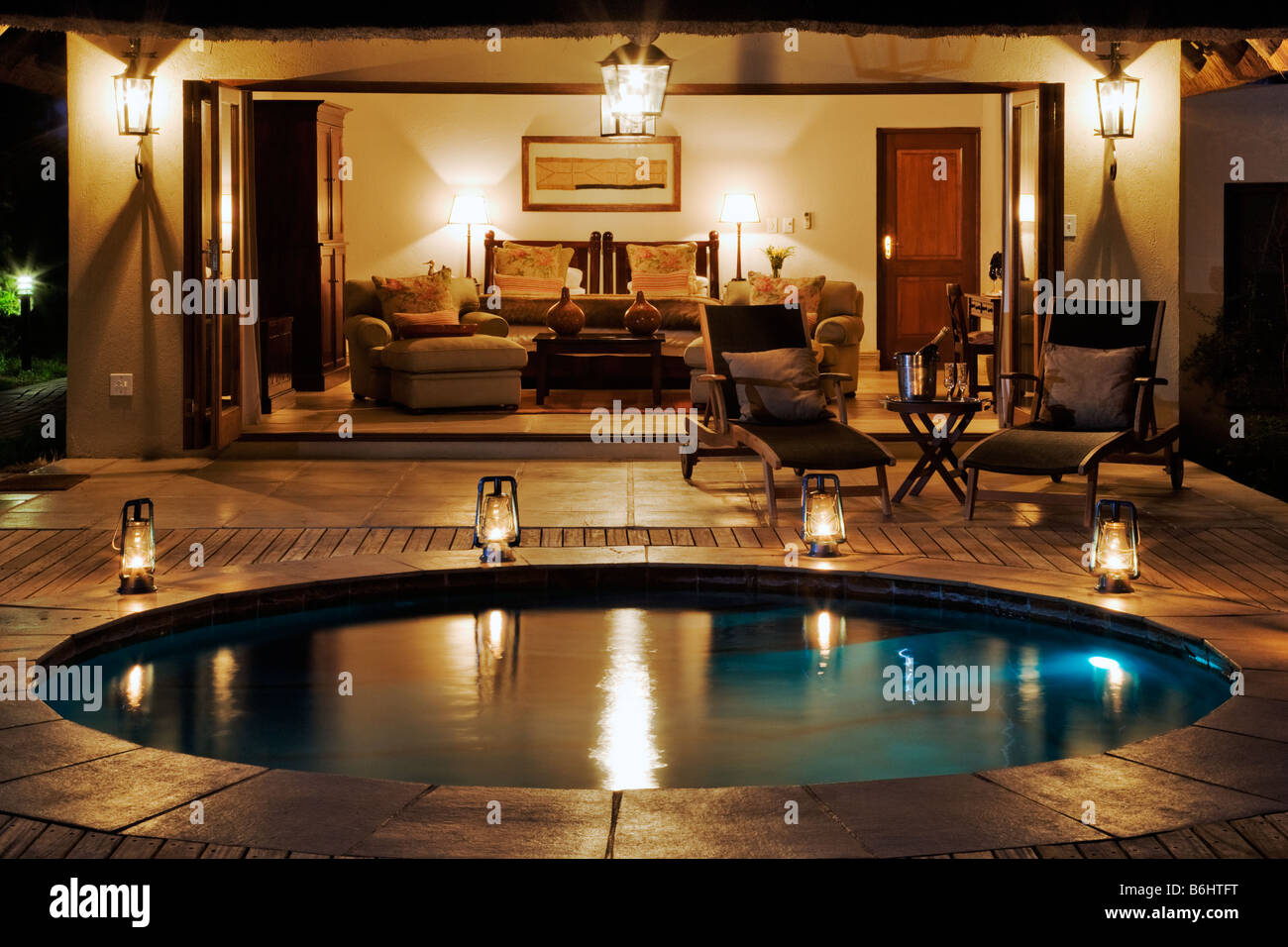 luxurious bedroom with a wooden deck and private plunge pool Savanna Suite Savanna Private Game Lodge Sabi Sand Game Reserve Stock Photo