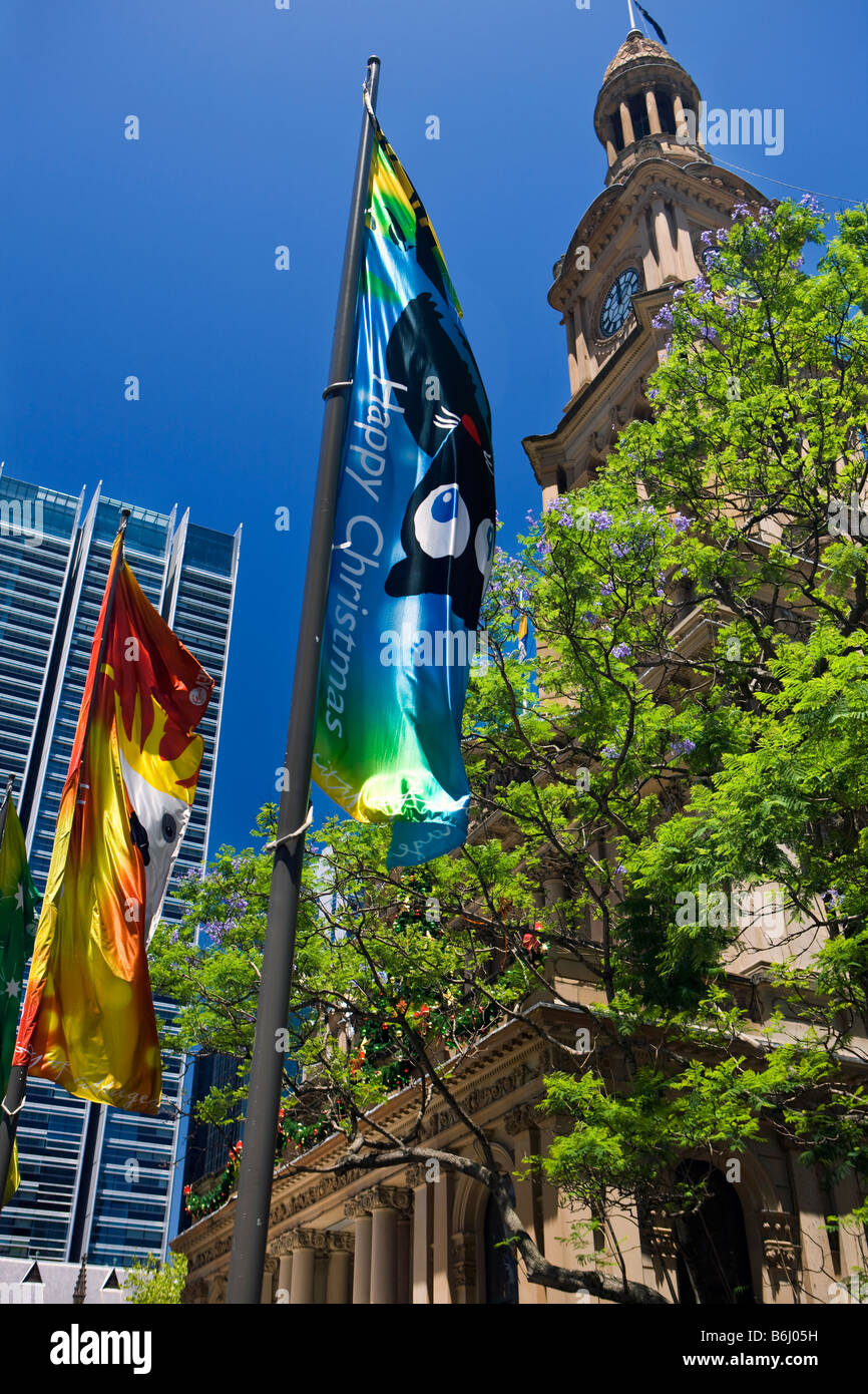 Banners saying Happy Christmas fly in front of Town Hall Sydney New South Wales Australia