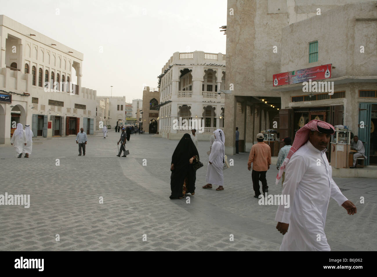 Locals strolling through the Souq Waqif market in Doha, Qatar. Stock Photo