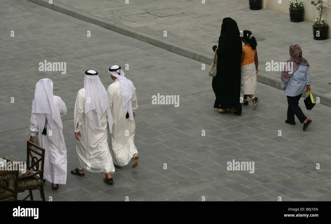 Qataris in traditional clothing walking along pavement, high angle view, Doha, Qatari, Middle East Stock Photo