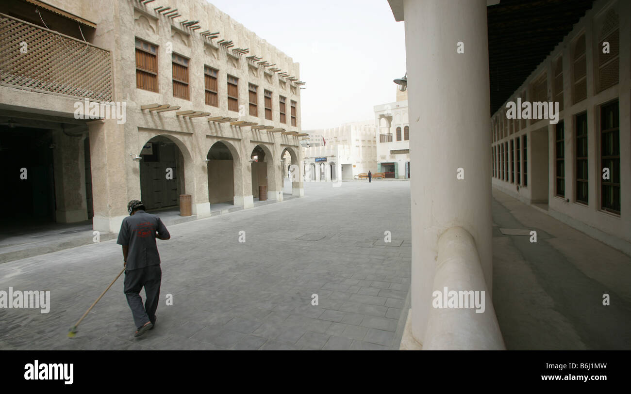 Man sweeping road at the Souq Waqif market, Doha, Qatar, Middle East Stock Photo
