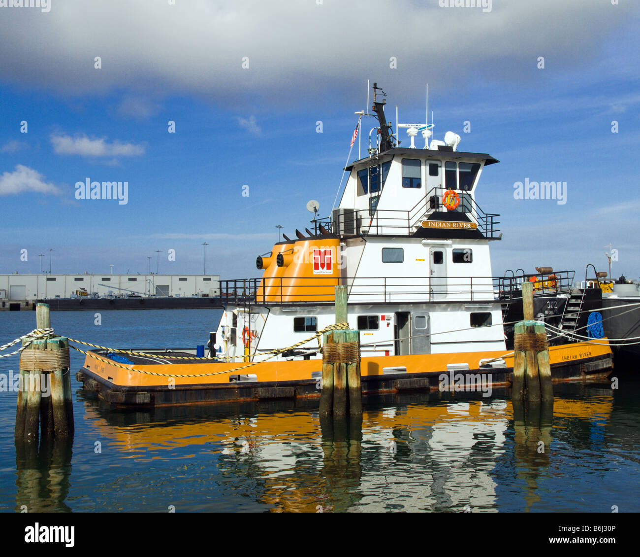 THE TUG INDIAN RIVER PUSHES FUEL OIL BARGES UP THE INDIAN AND HALIFAX