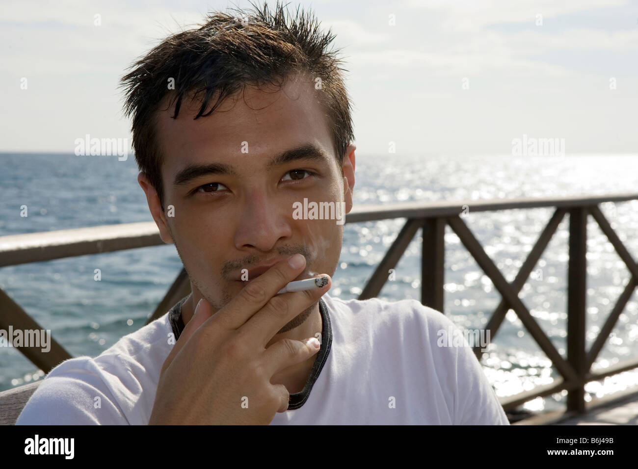 A portrait of a young man smoking Stock Photo