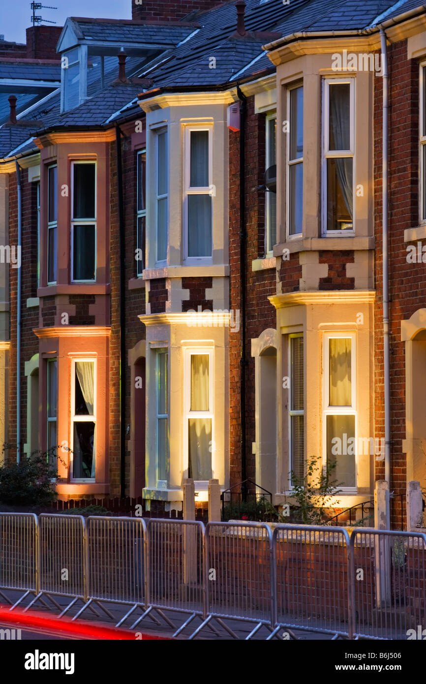 Terraced housing in a 1930s style on Belgrave Crescent opposite Ridley Park in Blyth, lit for