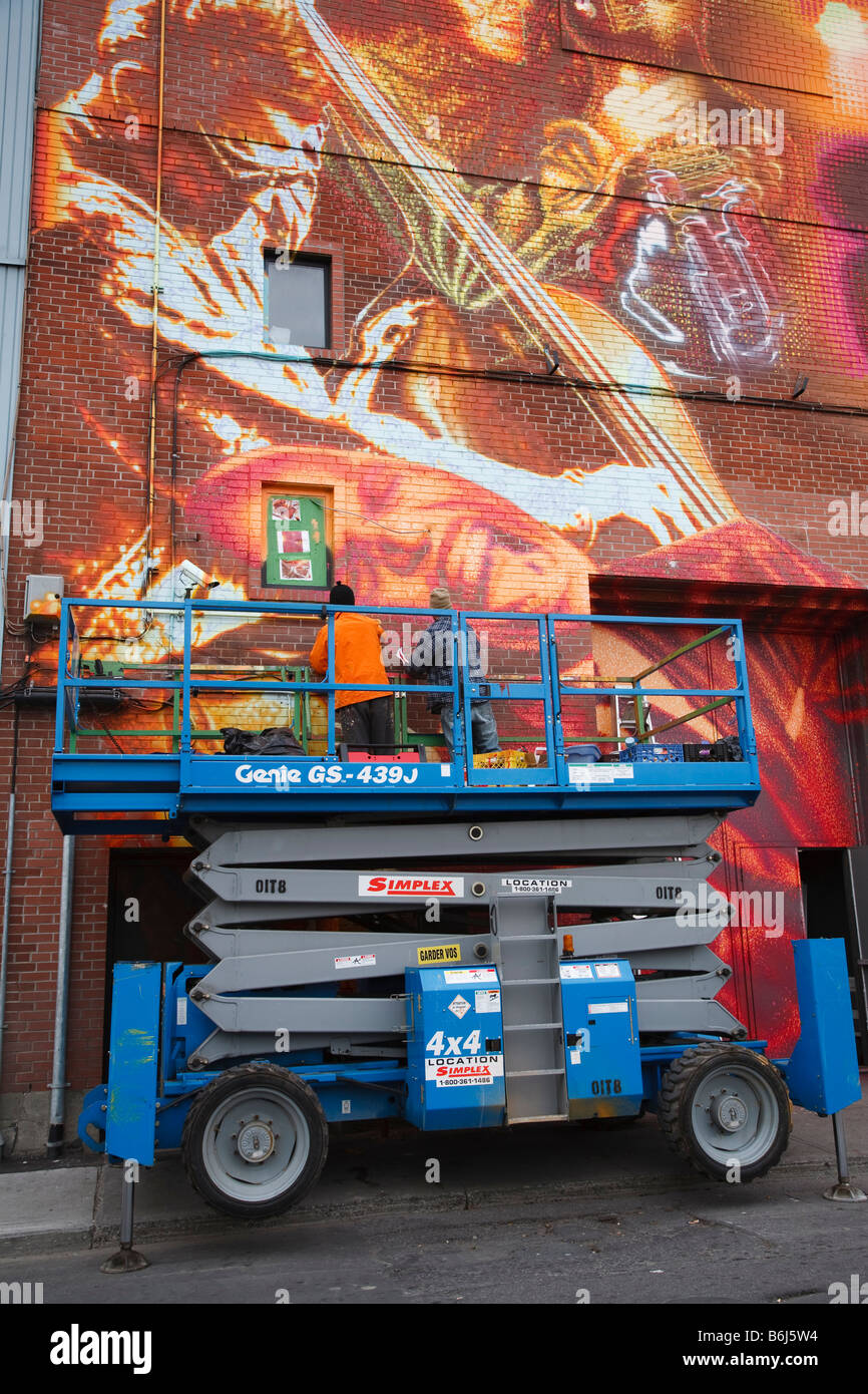 Graffiti artists painting wall mural Montreal Quebec Canada Stock Photo