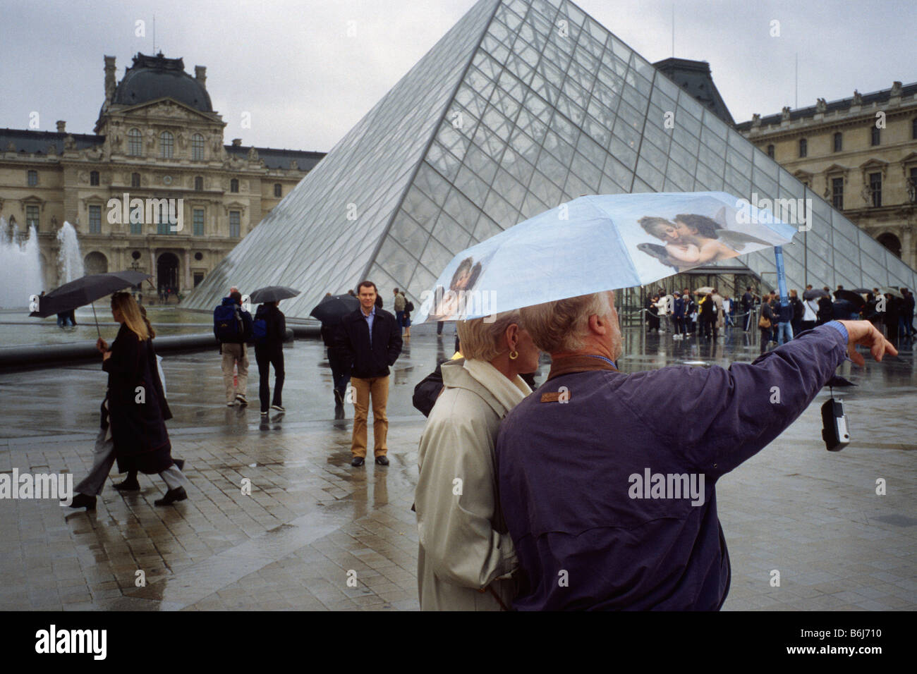 Paris France Tourists sightseeing on a rainy day the Louvre Paris Stock ...