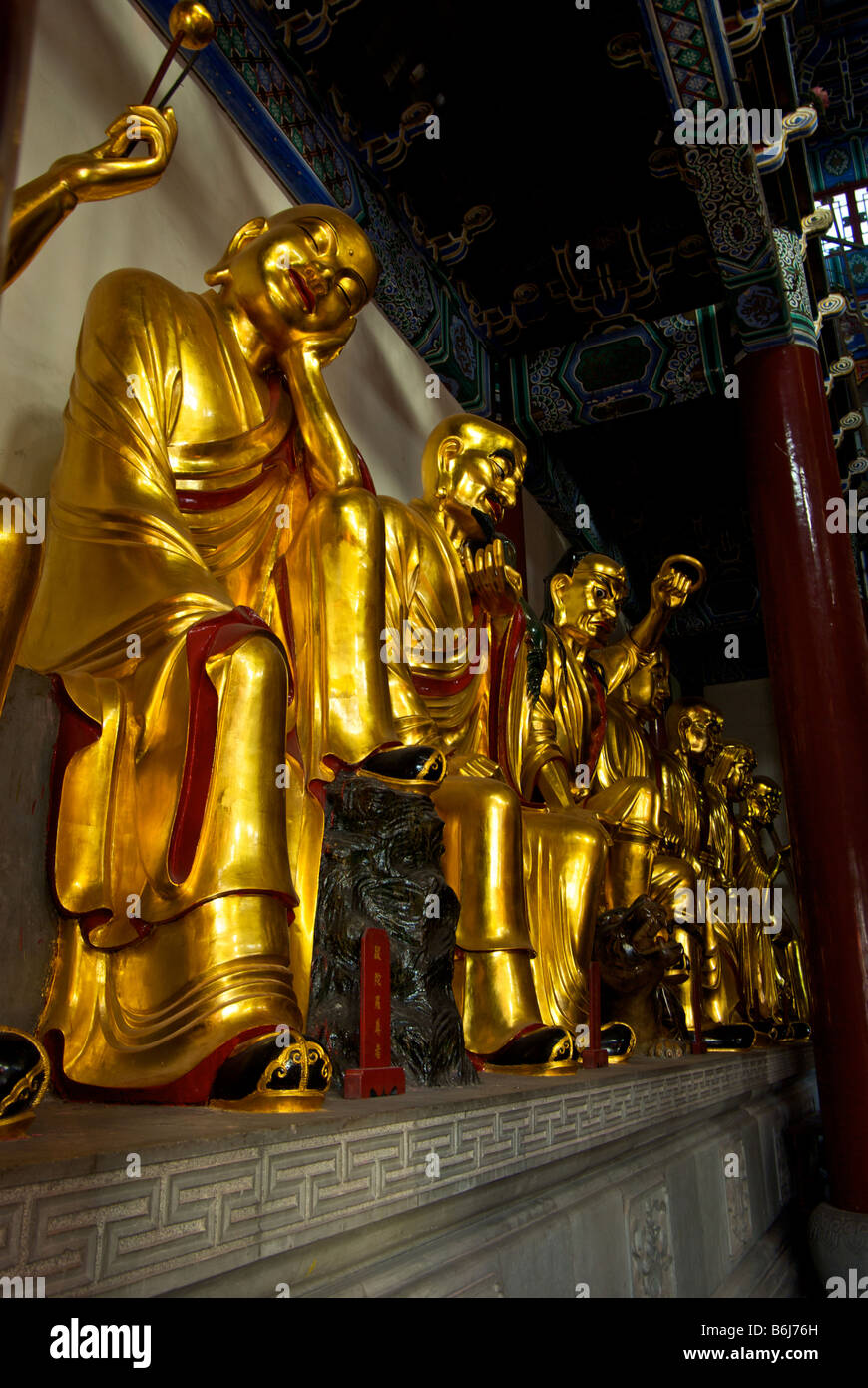 Gold statues of monks line the wall at Tang dynasty Zhenjiang Buddhist Temple and monastery on jinshan Golden Hill Stock Photo