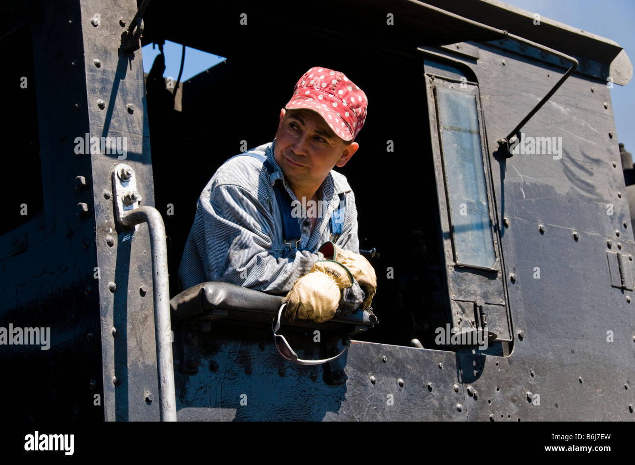 Train engineer looking out of cab on Old fashioned vintage