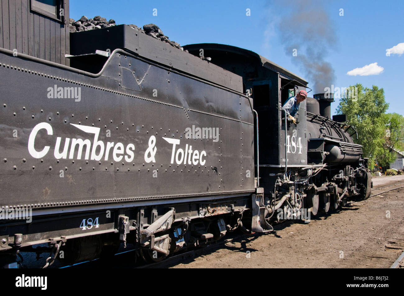 Old fashioned vintage locomotive train engine moving on tracks Stock Photo