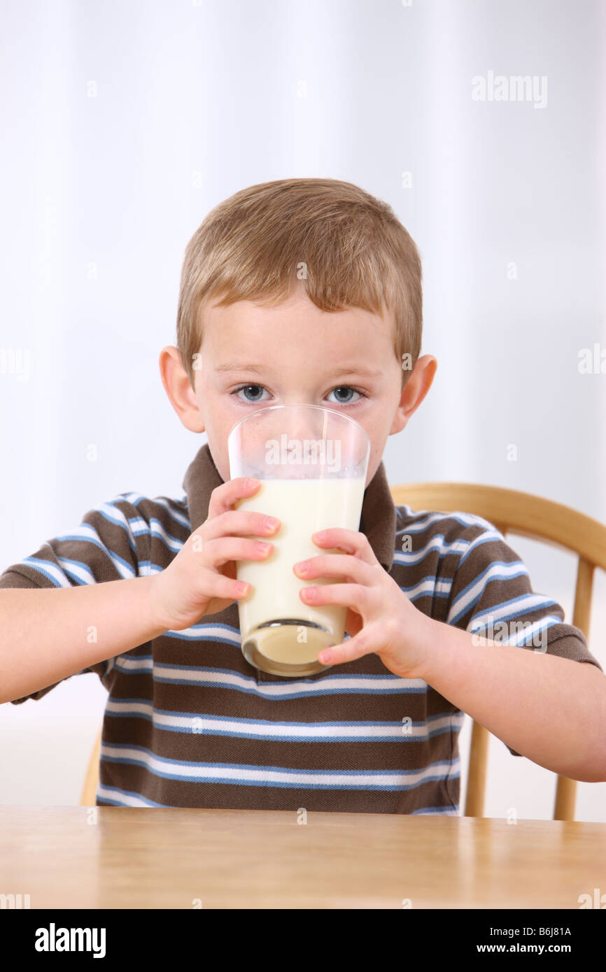 Young boy drinking glass of milk Stock Photo