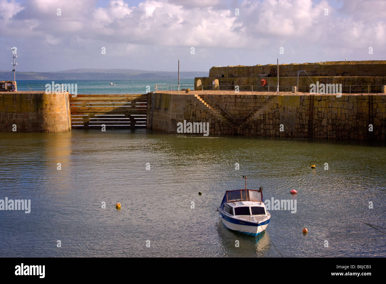 Mousehole harbour closed against winter storms by the baulk Stock Photo