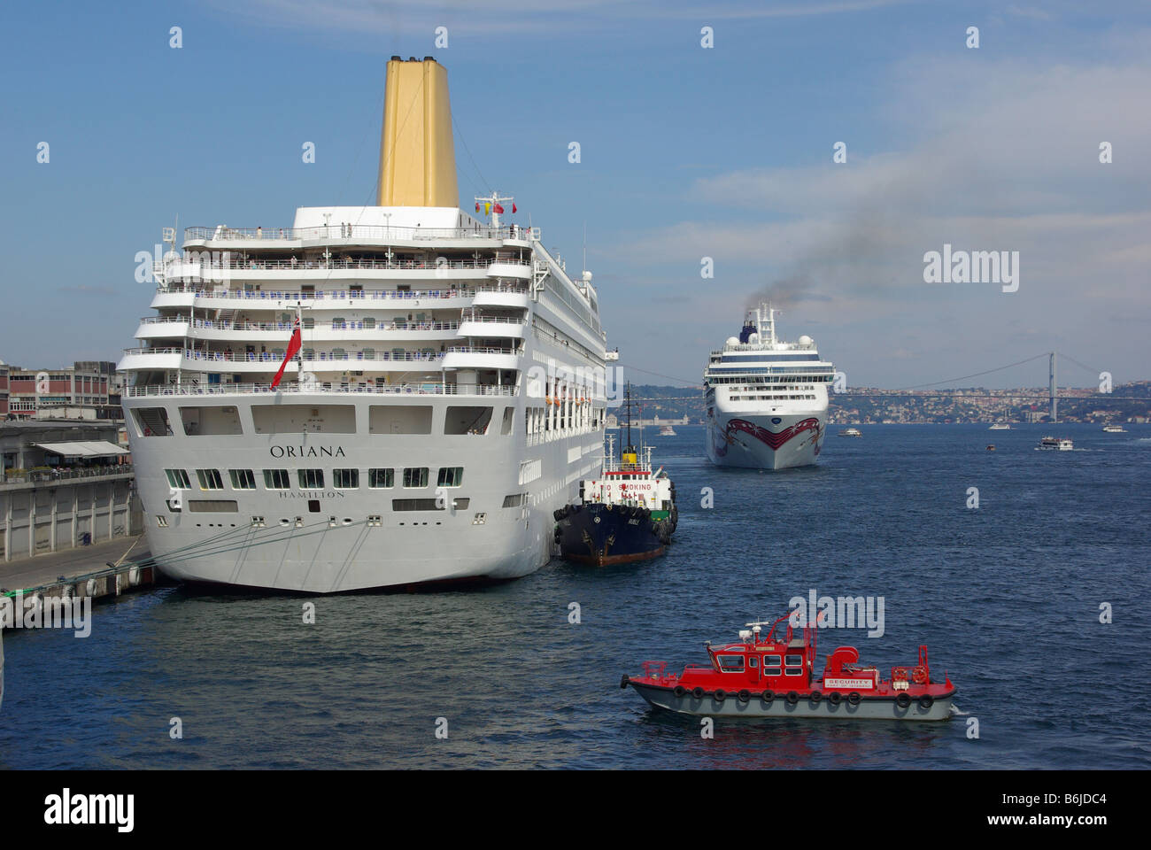 Istanbul Port Bosporus waterway cruise ship P&O Oriana red security launch & Norwegian Jewel ocean liner beyond bunkering ship attends Turkey Europe Stock Photo