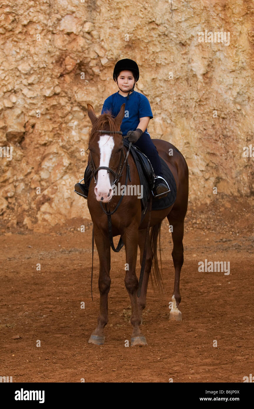 Young boy horseback riding Stock Photo