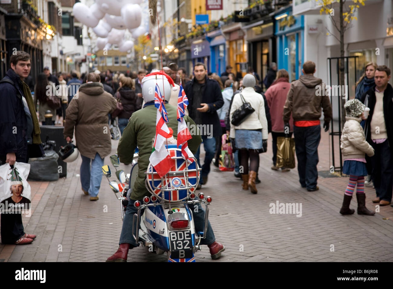 Lambretta scooter being ridden along Carnaby street in London amongst  christmas shoppers,England,Great Britain Stock Photo - Alamy