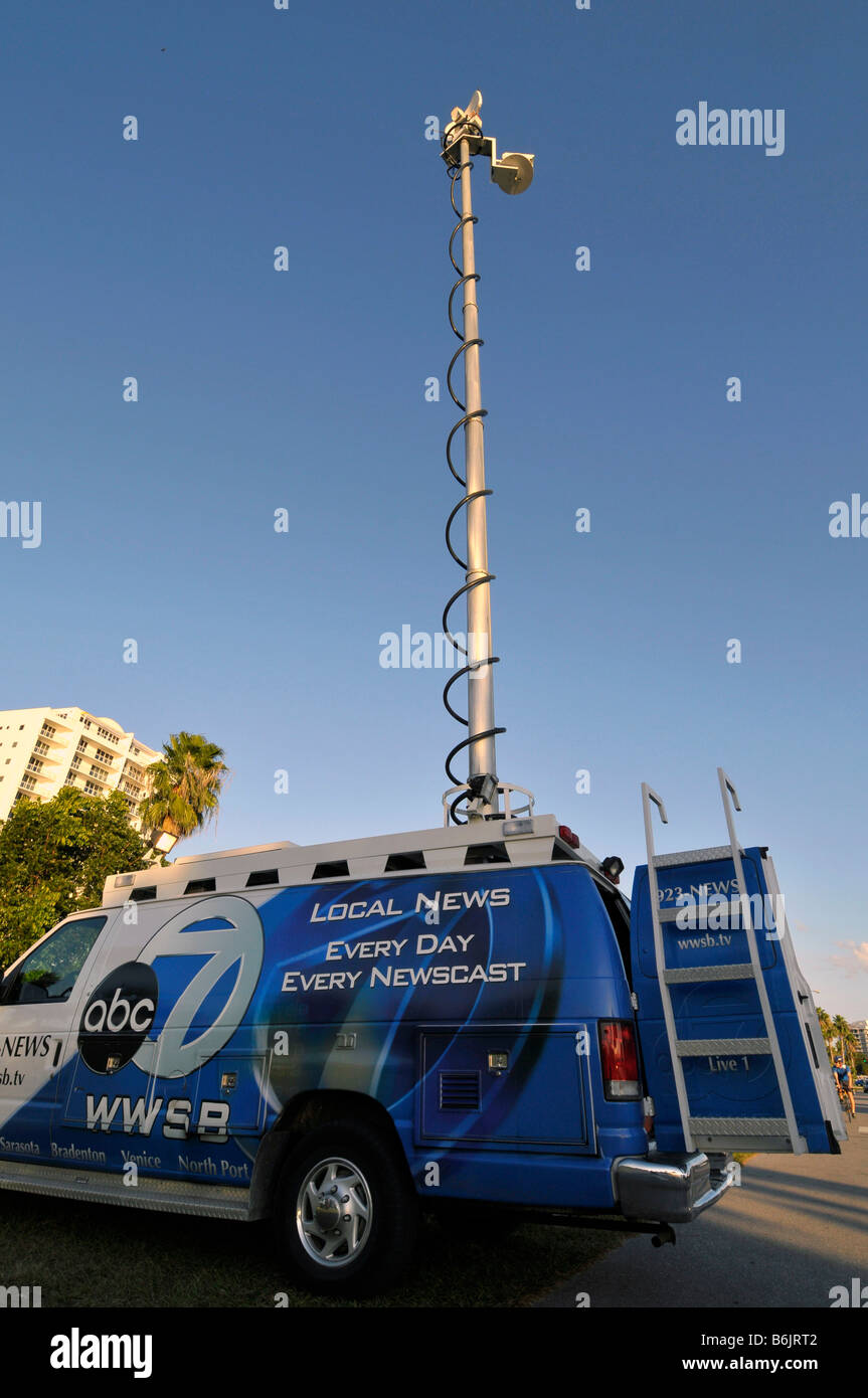 Television station remote broadcast van unit with satellite uplink antenna Stock Photo
