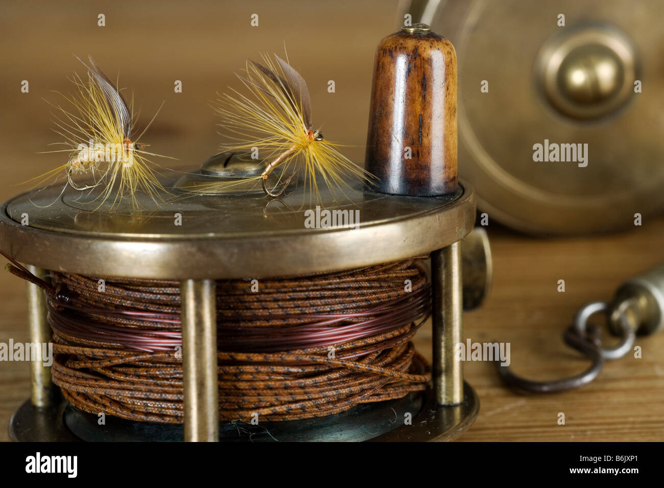 England.  Dry flies on a traditional brass fly fishing reel. Stock Photo