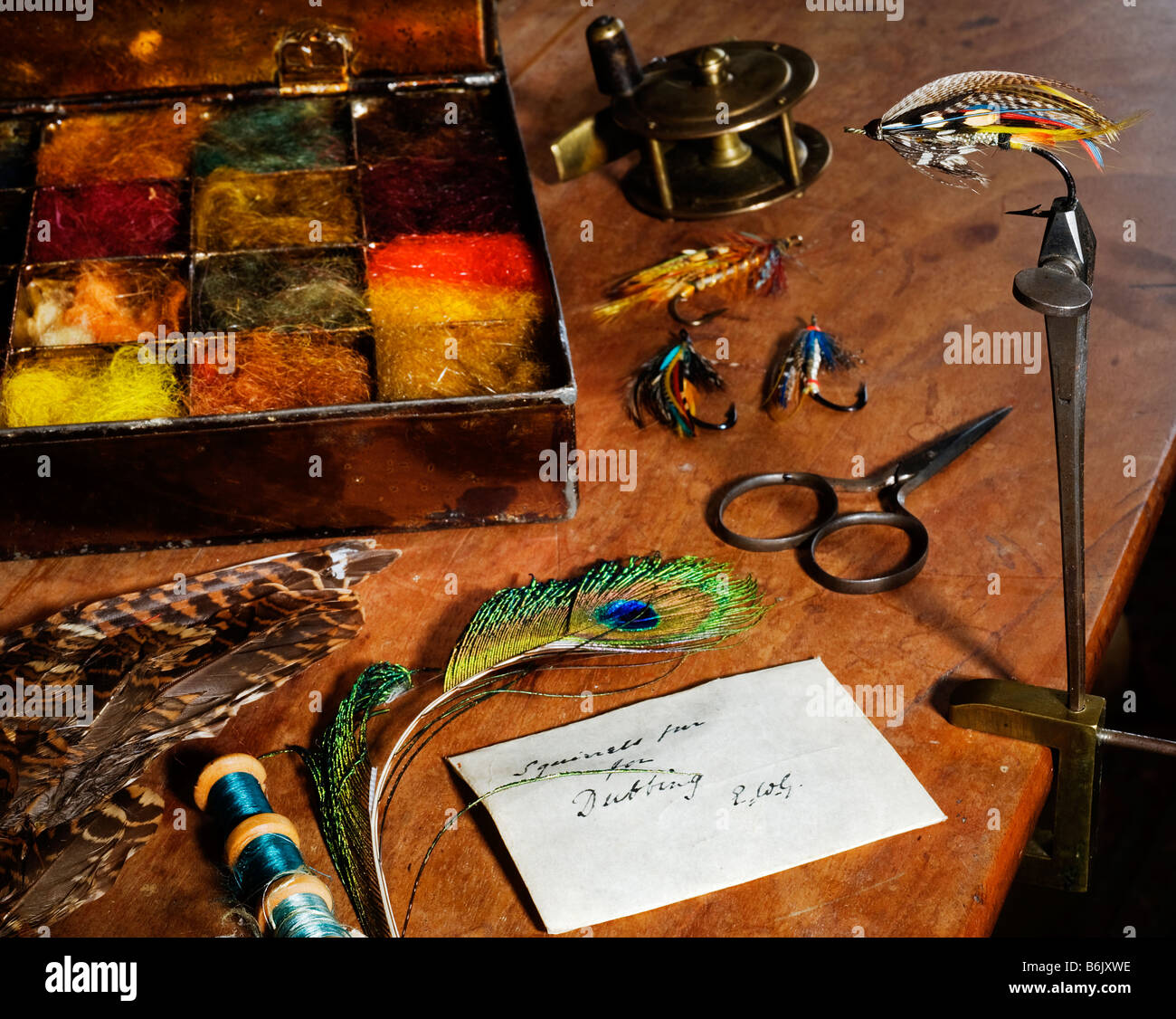 UK. Antique flytying equipment with a traditionally tied salmon fly in