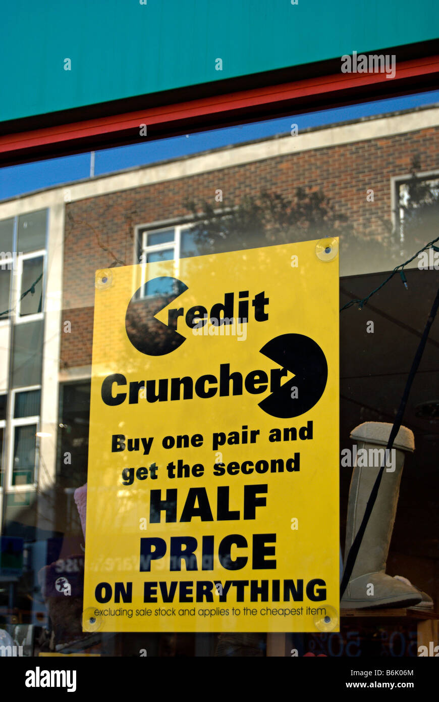 yellow and black shop window sign advertising a half price sale, in kingston upon thames, surrey, england Stock Photo